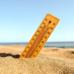 a-closeup-shot-of-a-thermometer-in-the-beach-sand-e1654851083306.jpg