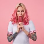 portrait-of-cute-girl-with-pink-hair-and-tattooed-hands-looking-and-enjoying-delicious-ice-cream-standing-wearing-a-white-t-shirt-scaled-e1654239252827.jpg