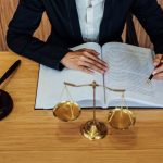 Gavel On Wooden Table And Female Lawyer Or Judge Working With Ag