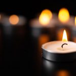 front-view-of-burning-candles-on-pitch-black-surface-scaled.jpg