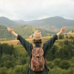 young-female-traveler-enjoying-rural-surroundings-scaled-e1683796653492.jpg