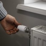 man-turning-off-radiator-during-energy-crisis-scaled-1.jpg