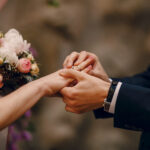 groom-putting-ring-on-bride-s-finger.jpg