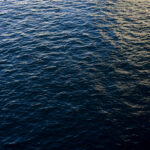 high-angle-shot-of-a-tranquil-ocean-with-soft-sunlight-scaled-1.jpg