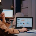 overworked-businesswoman-typing-financial-statistics-on-laptop-sitting-at-desk-table-in-startup-company-office-late-at-night_482257-2324