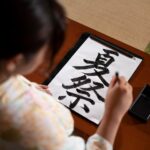 close-up-teacher-doing-japanese-calligraphy-called-shodo_23-2149105319