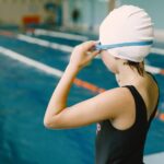 kid-preparing-put-goggles-she-is-about-jump-water-sports-hobbies_1157-49326