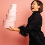 attractive-caucasian-young-woman-brunette-looking-gift-boxes-while-holding-her-hands-studio-holiday-concept_197531-31372