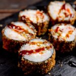 sushi-rolls-served-with-sauce-sesame-seeds_141793-980