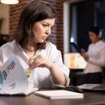 businesswoman-comparing-documents_482257-124313