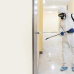 full-shot-man-disinfecting_23-2148926650