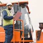 indian-man-working-male-yellow-vest-man-near-tractor_1157-47555
